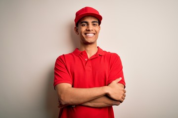 Young handsome african american man wearing casual polo and cap over red background happy face smiling with crossed arms looking at the camera. Positive person.
