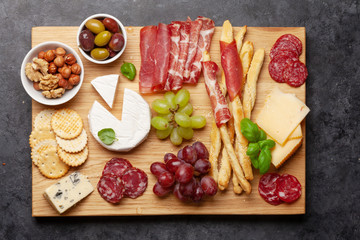 Fototapeta na wymiar Cheese, meat, grapes and olives antipasto