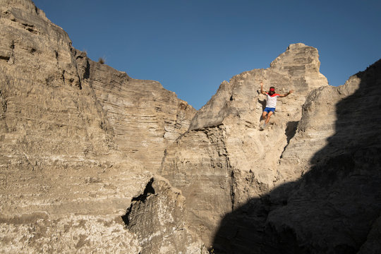 One man descending on a sandy and steep terrain at an old mining area