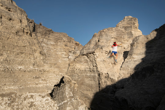 One man descending on a sandy and steep terrain at an old mining area