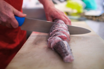 raw fish caught in the hand of the fisherman