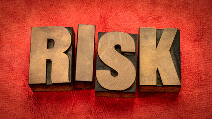 risk word abstract in wood type