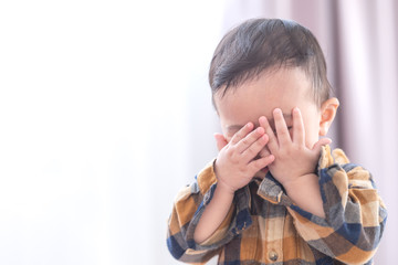 Asian baby boy playing hide and seek hiding face with parents,Concepts of learning development of...