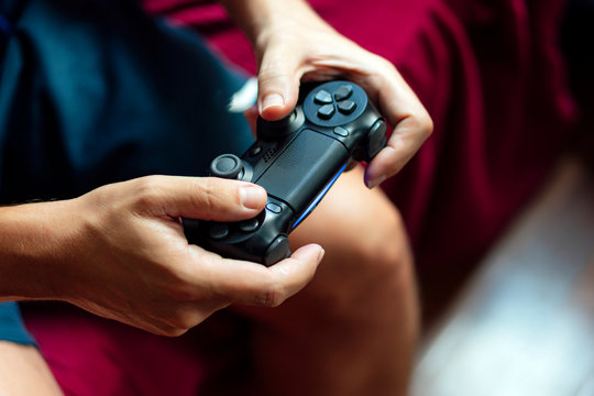 Close-up of a person playing the game console in the quarantine period