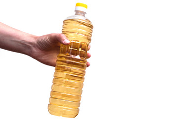 Sunflower oil in hand. A bottle of sunflower oil.