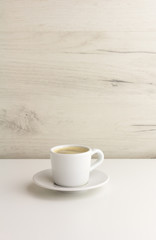 A little cup of espresso coffee on a light background