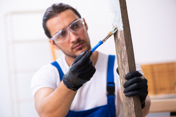 Young male contractor working in workshop