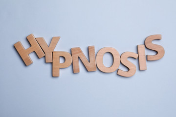 Fototapeta na wymiar Word HYPNOSIS made with wooden letters on light background, flat lay