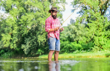 ideas to inspire you. fisherman show fishing technique use rod. man catching fish. mature man fly fishing. experienced fisher in water. Successful fly fishing. summer weekend. sport activity and hobby