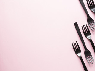 Forks on pink background. Plastic cutlery, ecology, environmental pollution by plastic, disposable tableware, waste recycling concept. copyspace, flat lay