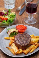 closeup of grilled steak with french fries