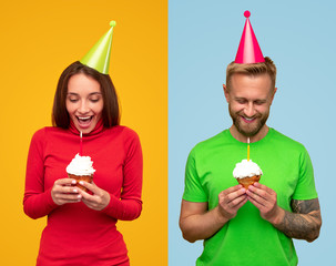 Cheerful couple with cupcakes celebrating holiday