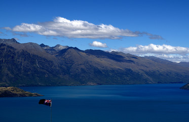 New Zealand Flag against amazing queenstown landscape