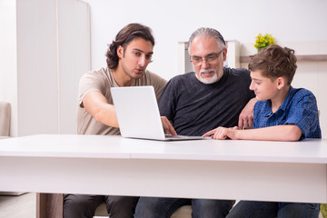 Fototapeta premium Grandfather learning new technology from son and grandson