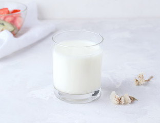The concept of fermented drinks. Milk kefir in a glass on a concrete background. Healthy food