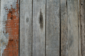 Wooden background made of old boards with spots of old paint.