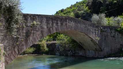 View of the Ponte Romano - Roman bridge at Ceniga Beach in Dro in the Valle del Sarca. The bridge was build in the XII century over the Sarca River to connect the villages of Dro and Arco.