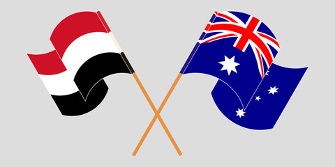 Crossed and waving flags of Yemen and Australia