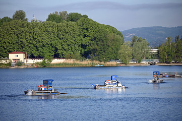 Fototapeta na wymiar Amphibious weed cutting boats on the Danube river Vienna Austria