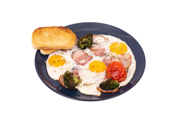 Traditional breakfast with fried eggs, pork ham, fried broccoli and tomato, isolated on white background, angle view