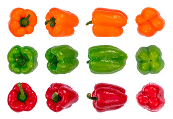 Orange, green and red bell peppers arranged in rows with water drops, isolated on white background. Organic fresh vegetables, macro photo