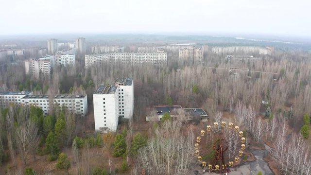 Ferris wheel in Pripyat, Chernobyl. With abandoned buildings in the exclusion zone. Aerial video with drone