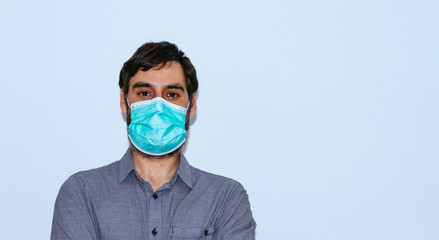 portrait of man with beard and casual clothes and surgical mask on white background. social distancing