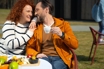 Beautiful couple enjoying each other company during breakfast outdoors