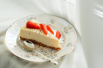 Piece of cheesecake with fresh strawberries  on white background