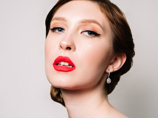 Glamour retro  portrait of a beautiful woman  with  stylish makeup and red lipstick 
