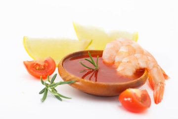 Delicious shrimps with sauce and lemon on white background. Tiger shrimps with rosemary and lspices.