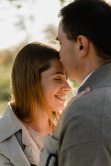 Fototapeta premium husband tenderly kisses his wife on the forehead,pregnant wife hugs husband