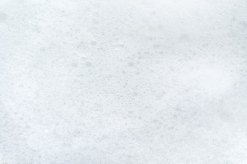 White soap suds. Back from small soap bubbles.