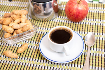 cup of expresso coffee with peanuts and fruit