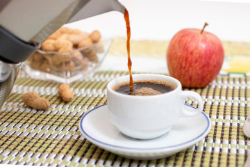 cup of expresso coffee with peanuts and fruit