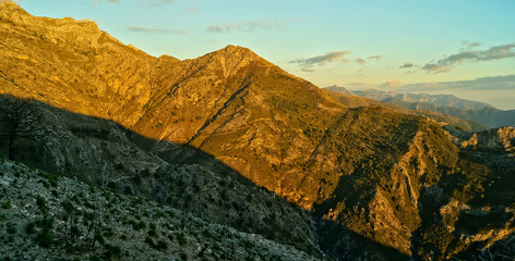 panoramic view from La Maroma mountain over Sierra de Tejeda and the andalusian coast with dusk sky