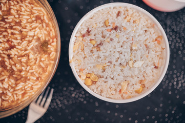 Top view of containers with different rice dishes of chinese food.