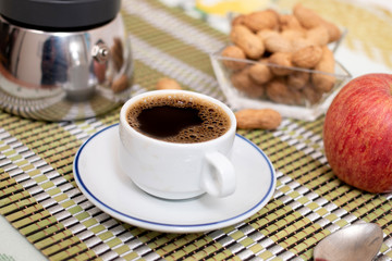 cup of expresso coffee with peanuts and fruit