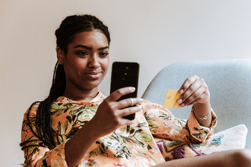 Ethnic woman shopping online at home