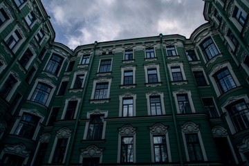 Bottom view of a beautiful green house. The houses of St. Petersburg.Windows of a big city.