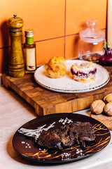 Well done home steak on black plate at kitchen and roaster meat original recipe