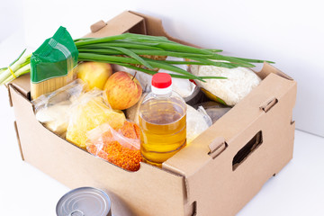 Donation. grocery box, help products to those in need. donation box. cardboard box with food essentials on a white background.