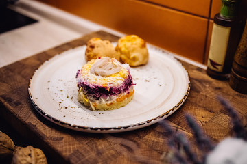 Fresh fish fashioned salad on white plate at home kitchen with two home buns