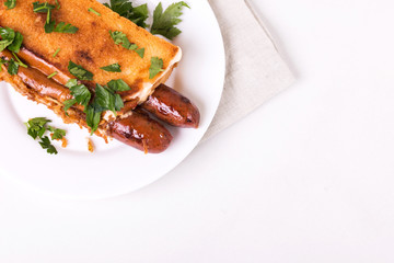 Double hot dogs with french brioche buns and caramelized onions with mayo sauce and ketchup.