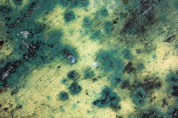 The green cement wall is dirty.