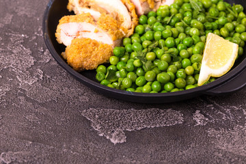 Chicken grilled fillet filled with julienne, lemon and steamed green pea. Healthy food, ketogenic diet. Keto/Paleo