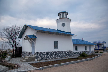 Fototapeta na wymiar View of a beautiful sea house with a blue roof. Ladoga Lake Russia.