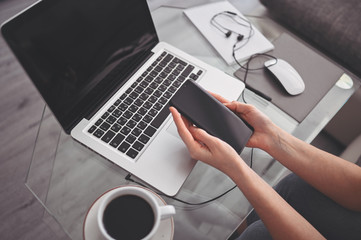 Female hands using smart phone in interior workplace, freelance business woman using cell phone at office desk, working from home using smart phone and notebook computer. Remote worker quarantine