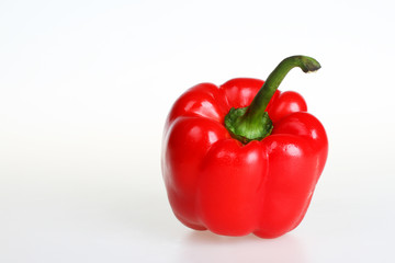 Two red bell peppers isolated on white