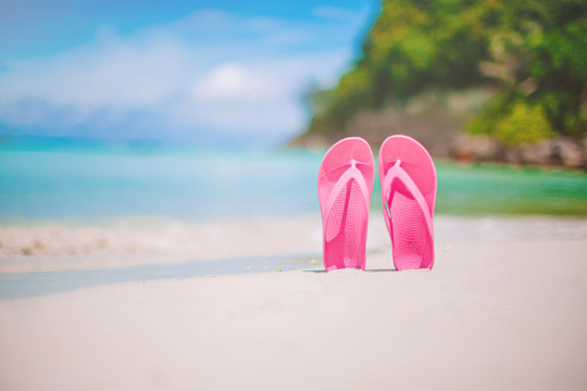 Colorful flipflop pair on the sea beach
